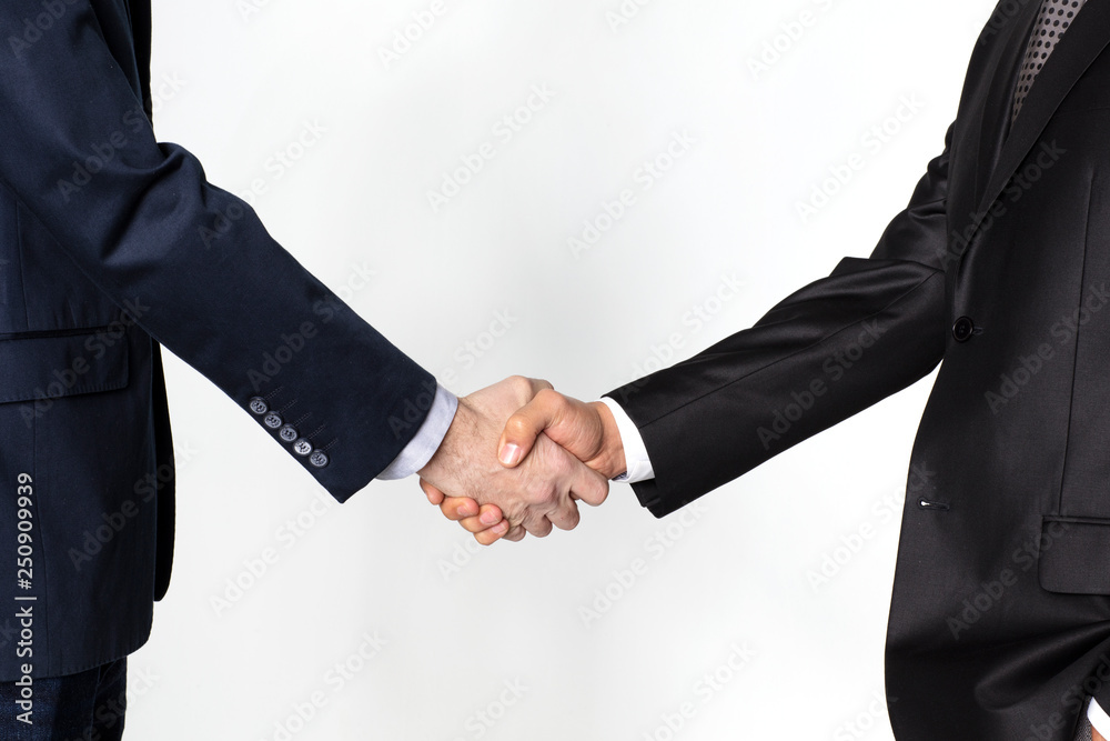 Wall mural Handshake between two businessmen isolated