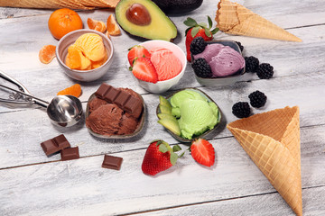 Set of ice cream scoops of different colors and flavours with berries, chocolate and fruits.