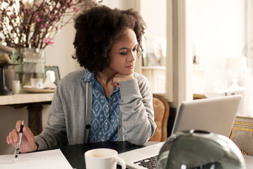 Woman at home using laptop  