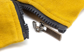 Broken zipper on yellow shirt jacket. Detail close-up photo © axivan.com