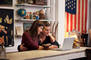 Couple sitting in front of laptop 