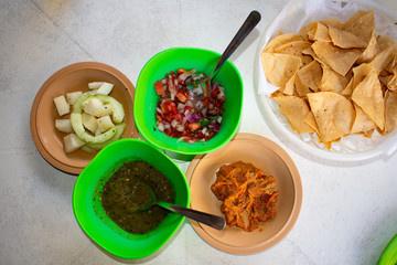 Top view on tradistional Mexican food, Tortilla chips with dip and salsa 