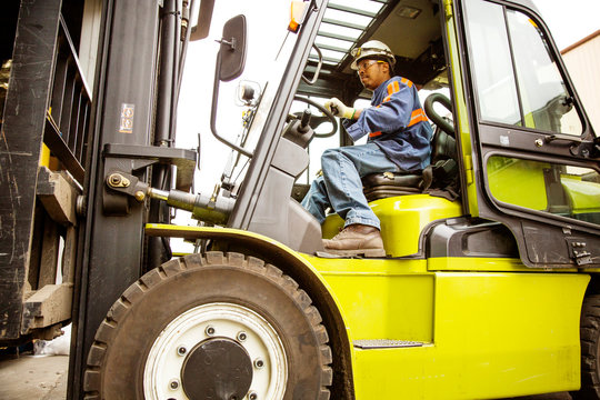 Manual worker driving forklift 