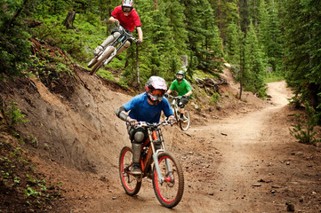 Bikers racing in forest Downhill mountain bike rally