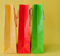 Colorful shopping bagss isolated on yellow background