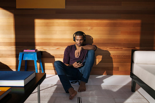 Young man listening to music on headphones