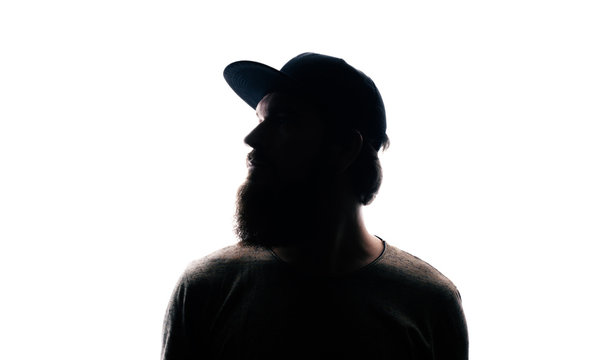 Bearded Man portrait silhouette in backlight. Handsome bearded mna looking away on white background