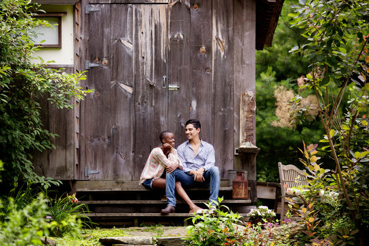 Young couple sitting on porch 