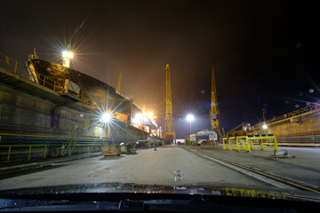 Plakat Vessel in a dry dock in Setubal, Portugal at night time