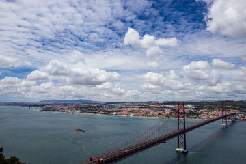 Fototapeta na wymiar Panoramic view of Ponte 25 de Abril, long bridge in Lisbon