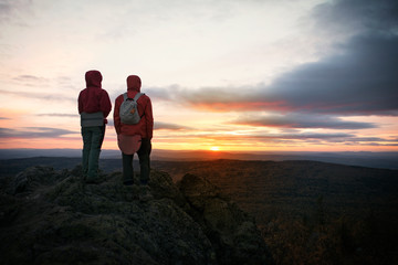 Silhouette of couple looking at sunset 