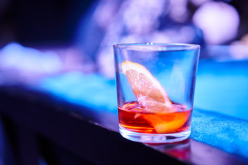 Glass with alcoholic refreshing on a bar table