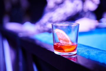 Glass with alcoholic refreshing on a bar table