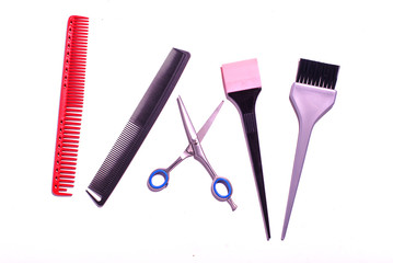 Combs and hairdresser tools on white background top view