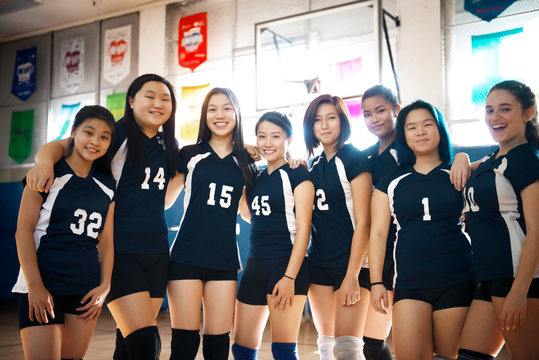 Team of volleyball players in sports hall 