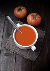 bowl of tomato sauce with tomatoes on rustic wood with natural light