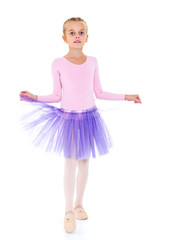 Little girl ballerina performs dance.