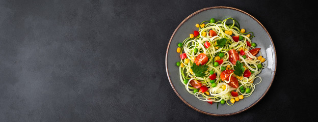 Zoodlie, healthy vegan food - zucchini noodlie with fresh green peas, tomato, bell pepper and corn...