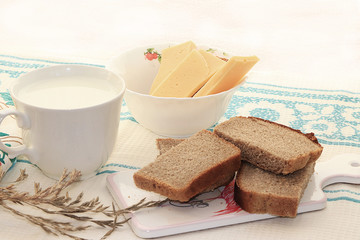 Country breakfast, milk and cereal bread, slices of cheese, healthy and healthy food