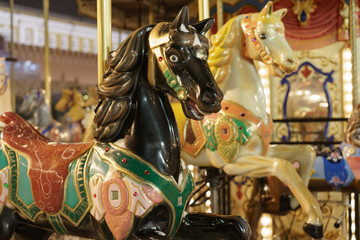 Fototapeta na wymiar Riding around a horses carousel 