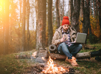 Young blogger photographer travel in mountain forest