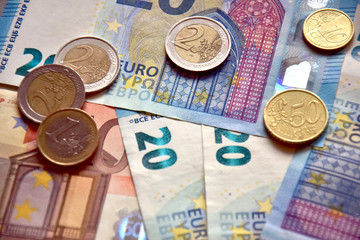 Euro banknotes and coins on the table