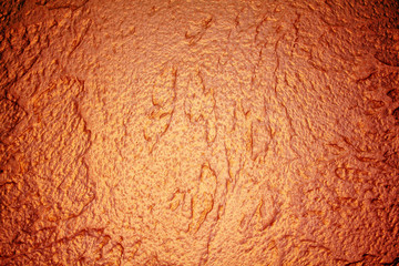 old textured wall with decorative plaster. stylized bronze, copper, metal.