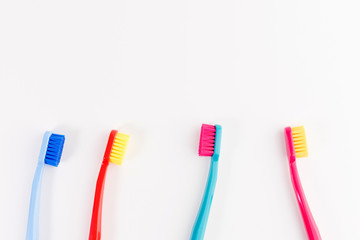 Red, pink, blue and light blue toothbrushes. Taking care of teeth, dental concept. Flat lay photo, copy space, top view