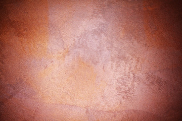 old textured wall with decorative plaster. stylized bronze, copper, metal.