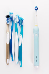 Manual Regular Toothbrush Against Modern Electric Toothbrush. Isolated on White Background