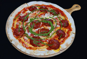 Thin crust beef pepperoni pizza with basil pesto sauce
