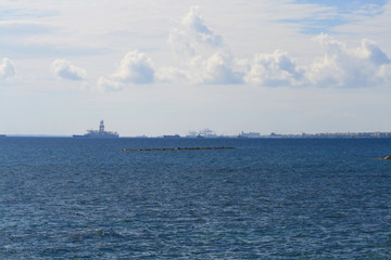 Blue sea with ships and sky with clouds