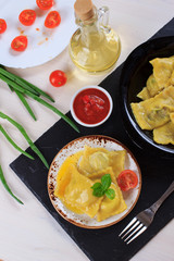Step by step recipe of italian ravioli with potato filling. Step 7. Woman cooking traditional homemade Italian food concept