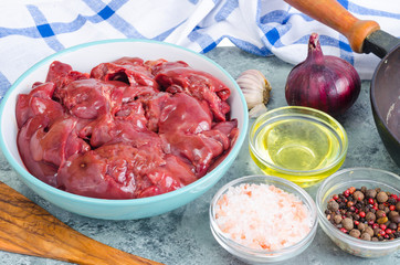 Raw chicken liver for cooking, spices, oil.