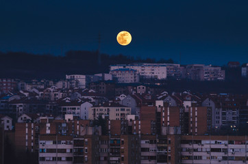 Full moon rising over the city