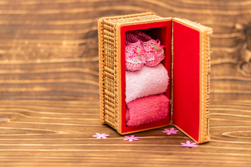decoration with pink baby shoe, wooden background, space for text