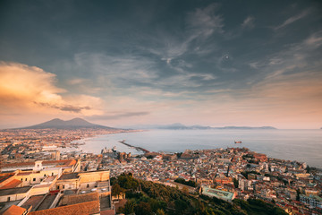 Naples, Italy. Skyline Cityscape City In Evening Sunset. Tyrrhenian Sea And Landscape With Volcano Vesuvius