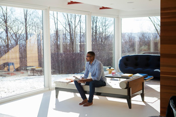 Young man looking through window 