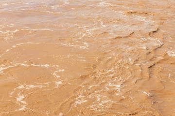 Brown flowing water after heavy rains