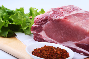 Raw pork chops with herbs and spices on cutting board. Ready for cooking.