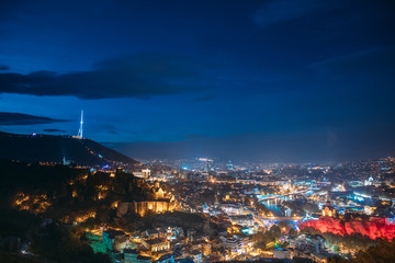 Fototapeta premium Tbilisi, Georgia. Top View Of Georgian Capital City Skyline Cityscape In Night Illuminations. Georgian Capital Skyline Cityscape