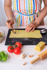 Step by step recipe of italian ravioli with potato filling. Step 1. Woman cooking traditional homemade Italian food concept
