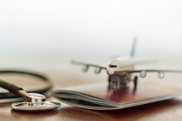 Stethoscope , passport document and airplane: Medical Travel concept
