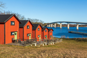 Camping cabins by a bridge in the Swedish archipelago