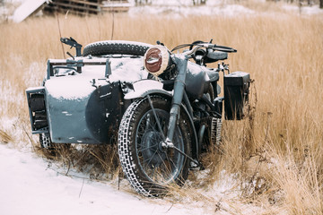 Fototapeta premium Old Tricar, Three-Wheeled Motorbike Of Wehrmacht, Armed Forces Of Germany Of World War II Time In Winter Forest