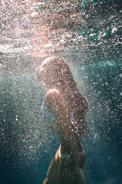 Young women diving underwater 