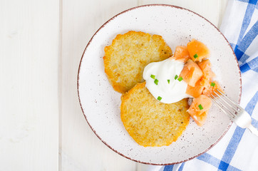 Potato pancakes with white sauce and smoked salmon