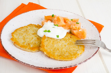 Potato pancakes with white sauce and smoked salmon