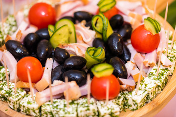 appetizers with cheese, ham, olives and tomatoes