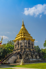 Fototapeta premium Old elephant chedi with golden top pagoda at Wat Chiang Man or Wat Chiang Mun, the oldest temple in Chiang Mai, Thailand, built in 1296 by King Mengrai in Lanna-style with elephant-shaped buttresses.